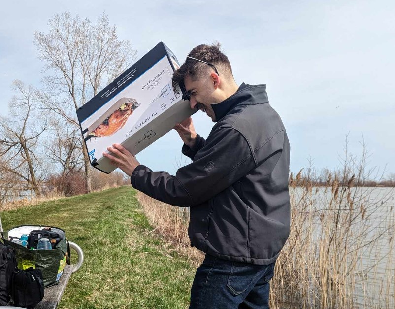 The author, staring into a large box, originally for a turkey roasting pan.