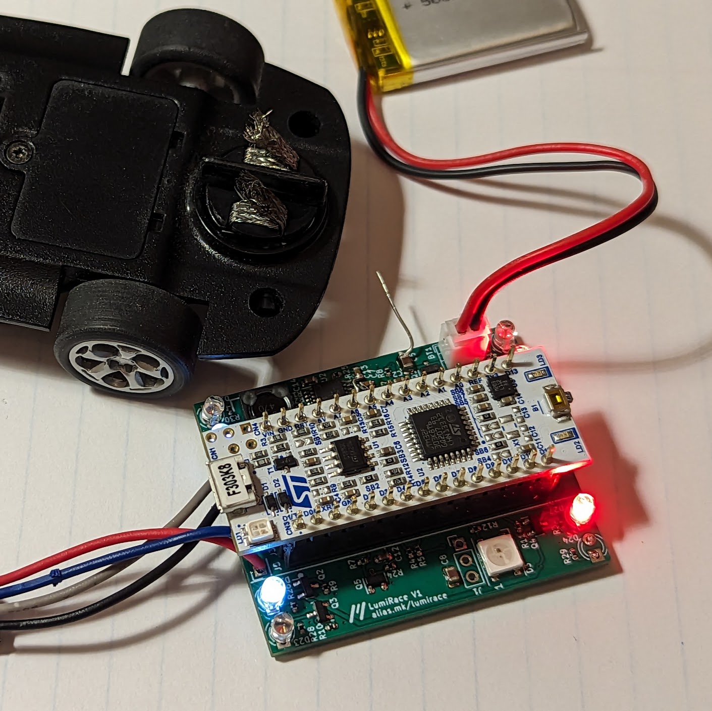 Photo of the LumiRace Prototype 1 next to a slot car
